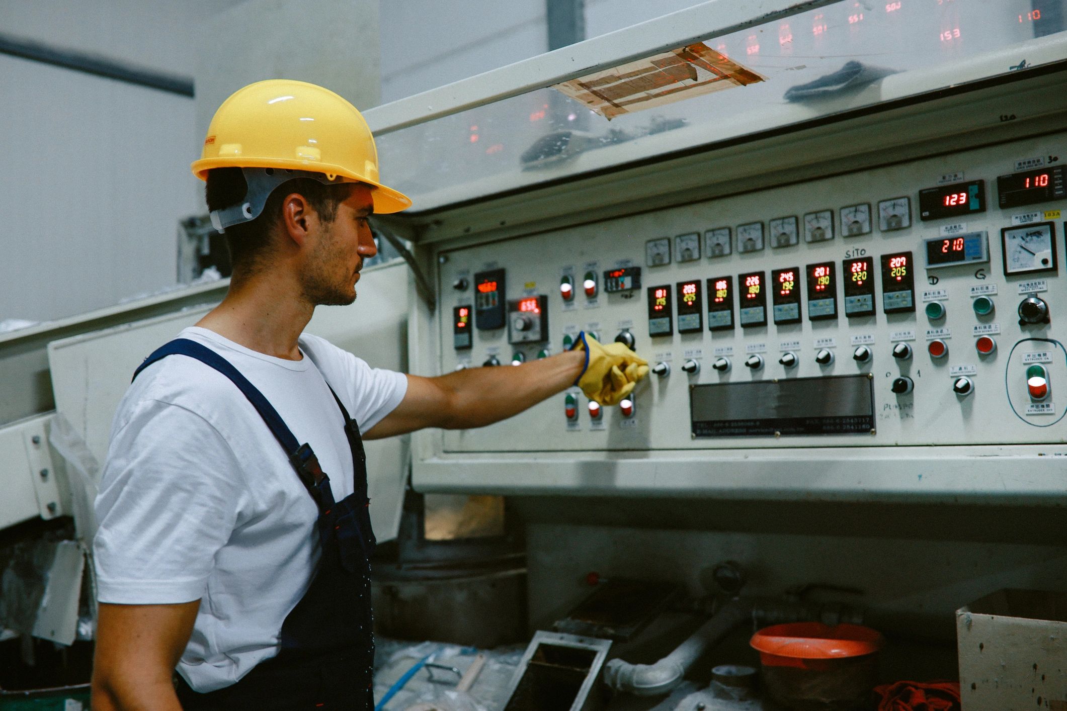 Electrician working on industrial control panel
