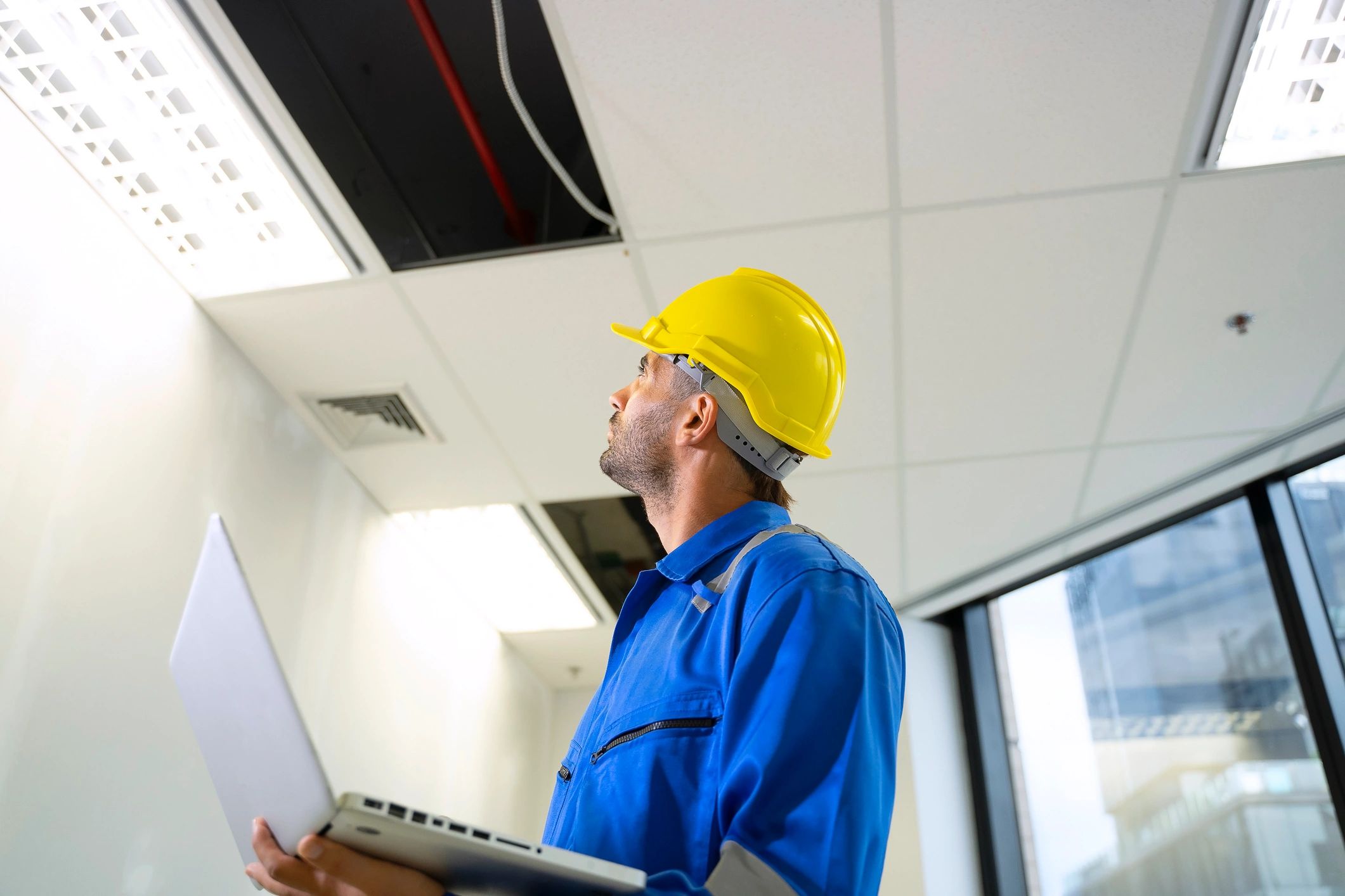 Electrician inspecting wiring on a job site