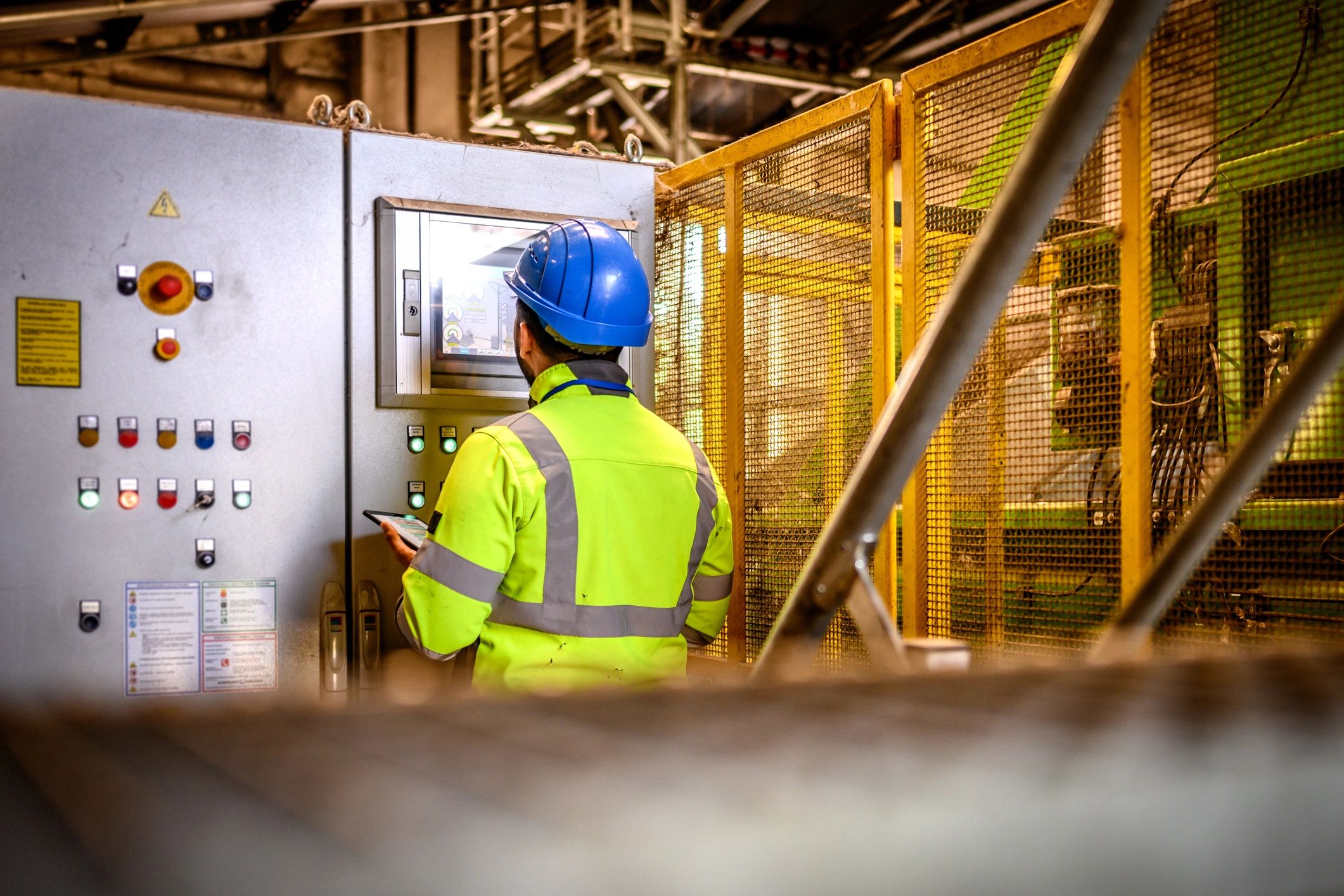 Worker monitoring an industrial control panel